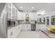 Modern kitchen features white cabinets, stainless appliances, granite countertops and a view to the backyard at 10317 Roadstead W Way, Raleigh, NC 27613
