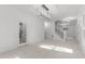 Open floor plan featuring hardwood floors, modern light fixture, staircase and view to the kitchen at 10317 Roadstead W Way, Raleigh, NC 27613
