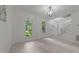 Living room features neutral walls, a contemporary chandelier, wood look floors and large windows at 10317 Roadstead W Way, Raleigh, NC 27613