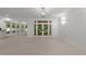 Spacious living room with french doors leading to patio, and neutral paint and wood floors at 10317 Roadstead W Way, Raleigh, NC 27613