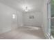Bright and airy living room features neutral paint and modern chandelier at 10317 Roadstead W Way, Raleigh, NC 27613