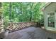 Back deck with wooden railing overlooking lush green scenery and trees at 104 Tutbury Pl, Cary, NC 27519