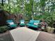 Relaxing back deck with cozy seating and lush greenery offering a serene outdoor space at 104 Tutbury Pl, Cary, NC 27519
