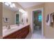 Bathroom featuring double sinks, marble countertops, and a private toilet at 104 Tutbury Pl, Cary, NC 27519