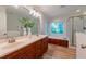 Bright bathroom with double vanity, soaking tub, and glass shower enclosure at 104 Tutbury Pl, Cary, NC 27519