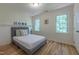 Comfortable bedroom with hardwood floors, wainscoting, and neutral tones at 104 Tutbury Pl, Cary, NC 27519