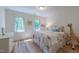 Bright bedroom with hardwood floors, neutral tones, and large windows at 104 Tutbury Pl, Cary, NC 27519