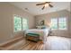 Well-lit bedroom with wood flooring, two bright windows and seating and storage at 104 Tutbury Pl, Cary, NC 27519