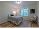 Simple bedroom with hardwood floors, neutral tones, and a cozy chair at 104 Tutbury Pl, Cary, NC 27519
