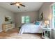 Cozy bedroom with lots of light, a ceiling fan and wood-look flooring at 104 Tutbury Pl, Cary, NC 27519