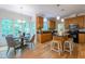 Sunny breakfast nook with a view of the kitchen island and the hardwood floors at 104 Tutbury Pl, Cary, NC 27519