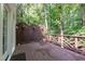 Outdoor living on the wooden deck with lattice railing and privacy screen, surrounded by lush trees at 104 Tutbury Pl, Cary, NC 27519