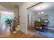 Dining area featuring hardwood floors, wainscoting, and a view of the staircase at 104 Tutbury Pl, Cary, NC 27519