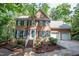 Charming two-story brick home with manicured landscaping, shutters, and a two-car garage at 104 Tutbury Pl, Cary, NC 27519