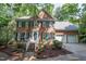 Charming two-story brick home with blue shutters, a two-car garage, and lush landscaping at 104 Tutbury Pl, Cary, NC 27519