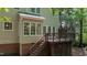 Two-story home exterior showcasing a wooden deck with stairs leading to backyard, and large picture windows at 104 Tutbury Pl, Cary, NC 27519