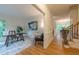 Open hallway leading to a bright office with a wooden desk and hardwood floors at 104 Tutbury Pl, Cary, NC 27519
