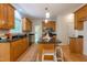 Bright kitchen with granite countertops, hardwood floors, and an island with stool seating at 104 Tutbury Pl, Cary, NC 27519