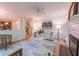Well-lit living room featuring a neutral color palette, fireplace, ceiling fan and easy access to kitchen and stairwell at 104 Tutbury Pl, Cary, NC 27519