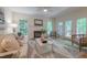 Cozy living room with a fireplace, a ceiling fan, and access to an outdoor deck at 104 Tutbury Pl, Cary, NC 27519