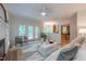 Bright living room with a fireplace, and white furniture with access to the back patio at 104 Tutbury Pl, Cary, NC 27519