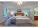 Spacious main bedroom with hardwood floors, ceiling fan, and bright natural light at 104 Tutbury Pl, Cary, NC 27519