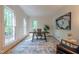 Bright home office with large windows, neutral decor, and a stylish rug and artwork at 104 Tutbury Pl, Cary, NC 27519