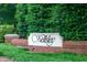 The Wellesley community entrance sign with brick base and lush green landscaping at 104 Tutbury Pl, Cary, NC 27519