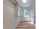 Walk-in closet with custom shelving, hardwood floors, and bright natural light at 104 Tutbury Pl, Cary, NC 27519