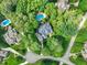 Aerial view of a stunning home surrounded by lush greenery and a sparkling blue pool at 10540 Byrum Woods Dr, Raleigh, NC 27613