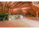 A spacious unfinished attic with exposed wood beams and ample room for storage or future expansion possibilities at 10540 Byrum Woods Dr, Raleigh, NC 27613