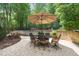 Brick patio with outdoor furniture, landscaping, and a view of the fenced-in swimming pool at 10540 Byrum Woods Dr, Raleigh, NC 27613