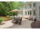 Brick patio area features comfortable seating and an umbrella for shade at 10540 Byrum Woods Dr, Raleigh, NC 27613