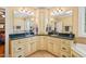 Dual sink bathroom with granite countertops, cream cabinets, and tile flooring at 10540 Byrum Woods Dr, Raleigh, NC 27613