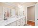 Bathroom with double sinks, a large mirror, and an adjoining room at 10540 Byrum Woods Dr, Raleigh, NC 27613