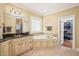Bright bathroom featuring a tub, vanity with a dark countertop, and a walk-in closet at 10540 Byrum Woods Dr, Raleigh, NC 27613