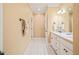 Bathroom with double sink, white cabinets, tile floors, and neutral paint at 10540 Byrum Woods Dr, Raleigh, NC 27613