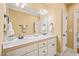 Bright bathroom featuring a double vanity, white cabinets, mirrors, and neutral paint at 10540 Byrum Woods Dr, Raleigh, NC 27613