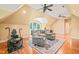 Upstairs bonus room with multiple seating areas, desk and large window at 10540 Byrum Woods Dr, Raleigh, NC 27613