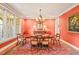Formal dining room featuring an elegant chandelier, rich color palette, and large windows at 10540 Byrum Woods Dr, Raleigh, NC 27613