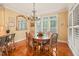 Dining area with a chandelier, natural light, and wood floors at 10540 Byrum Woods Dr, Raleigh, NC 27613