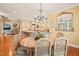 Dining area with a chandelier, natural light, and seamless access to the kitchen at 10540 Byrum Woods Dr, Raleigh, NC 27613