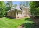 Home exterior with green lawn, landscaped beds, and back deck, complete with a brick facade at 10540 Byrum Woods Dr, Raleigh, NC 27613