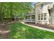 Backyard features a covered porch, patio, green lawn and mature trees around the perimeter of the house at 10540 Byrum Woods Dr, Raleigh, NC 27613