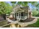Exterior home view shows the manicured yard, screened-in porch, and brick facade at 10540 Byrum Woods Dr, Raleigh, NC 27613