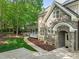 View of a beautiful, stone-accented home with a covered porch and manicured landscaping at 10540 Byrum Woods Dr, Raleigh, NC 27613