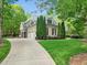 Beautiful home with lush landscaping, a circular driveway, and an inviting facade at 10540 Byrum Woods Dr, Raleigh, NC 27613