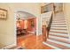 Elegant foyer with staircase, hardwood floors, and arched entry to the formal dining room at 10540 Byrum Woods Dr, Raleigh, NC 27613