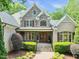 A beautiful brick and stone home with a manicured lawn, lush greenery, and an inviting entryway at 10540 Byrum Woods Dr, Raleigh, NC 27613