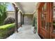Spacious covered stone porch featuring stone columns, and double wood doors at 10540 Byrum Woods Dr, Raleigh, NC 27613